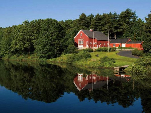 Iconic red-painted River Bend Farm Visitor Center by the Blackstone River and canal
