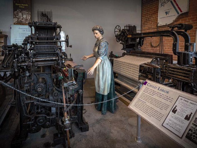 Statue of a woman working in a textile mill