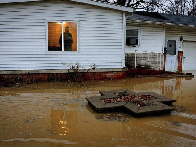 Centreville resident Earlie Fuse looks out his home window at the flooding that his filled his yard.