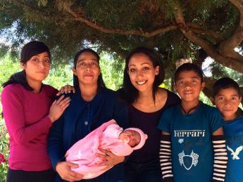 Global Health Equity Option Scholar Hanna Amanuel '16 (center) with a local family in Sierra Madre de Chiapas, Mexico. Amanuel spent this spring semester working with Compañeros En Salud México, Partners in Health's sister organization in Chiapas, as part of a new study-abroad program.