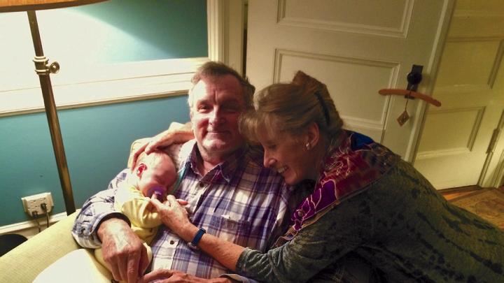 Photo of the Hrdys, author and husband, with their first grandchild