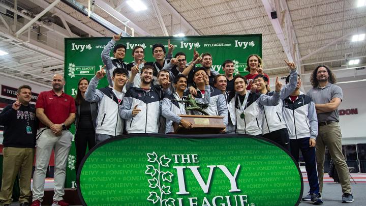 The Ivy champion men pose with their first-place trophy.