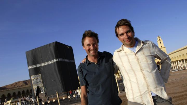 Cosmic Picture’s founders Taran Davies ‘93 (right) and Dominic Cunningham-Reid in Morocco. The structure behind them is a replica of the Ka‘ba, the most sacred site in Islam, built for production purposes. 