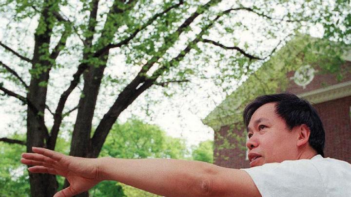 Master Yon Lee extends his hands in a tai chi pose.