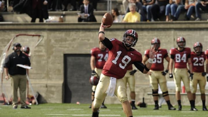 Harvard's Colton Chapple throws a football to an out-of-frame receiver.