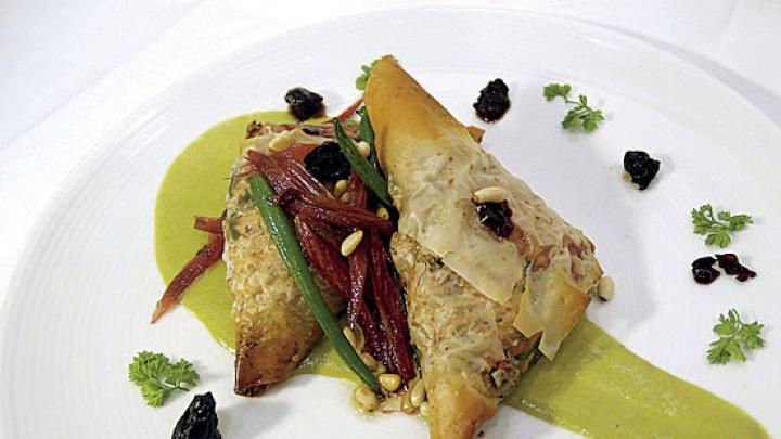 From the menu: phyllo triangles filled with caramelized onions, chard, and tofu, in a sorrel cream sauce