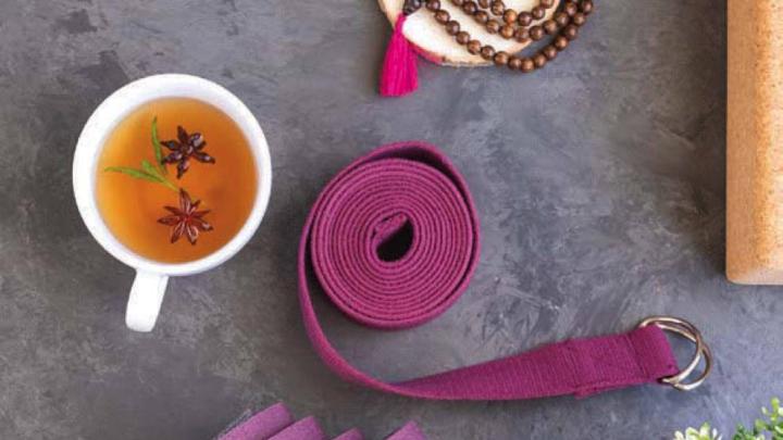 Yoga map, yoga strap, and cup of tea